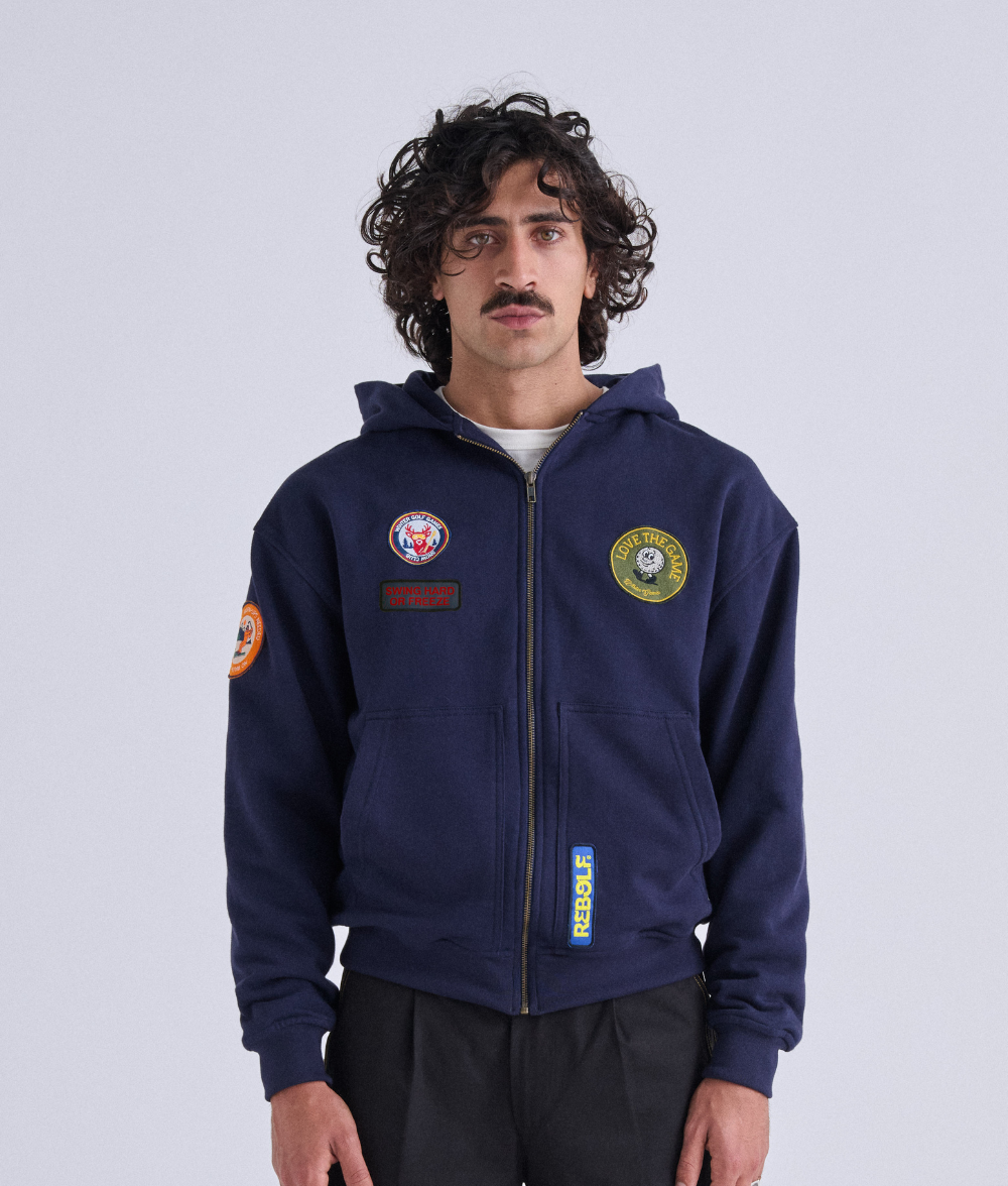 Model wearing the Rebolf Swing Or Freeze Hoodie in a relaxed sportswear look
